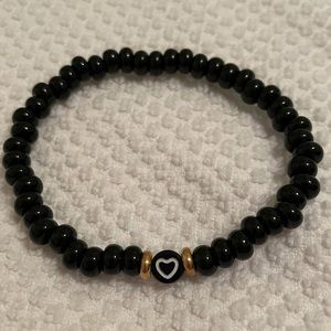 Check your heart polished black beaded stretch style bracelet